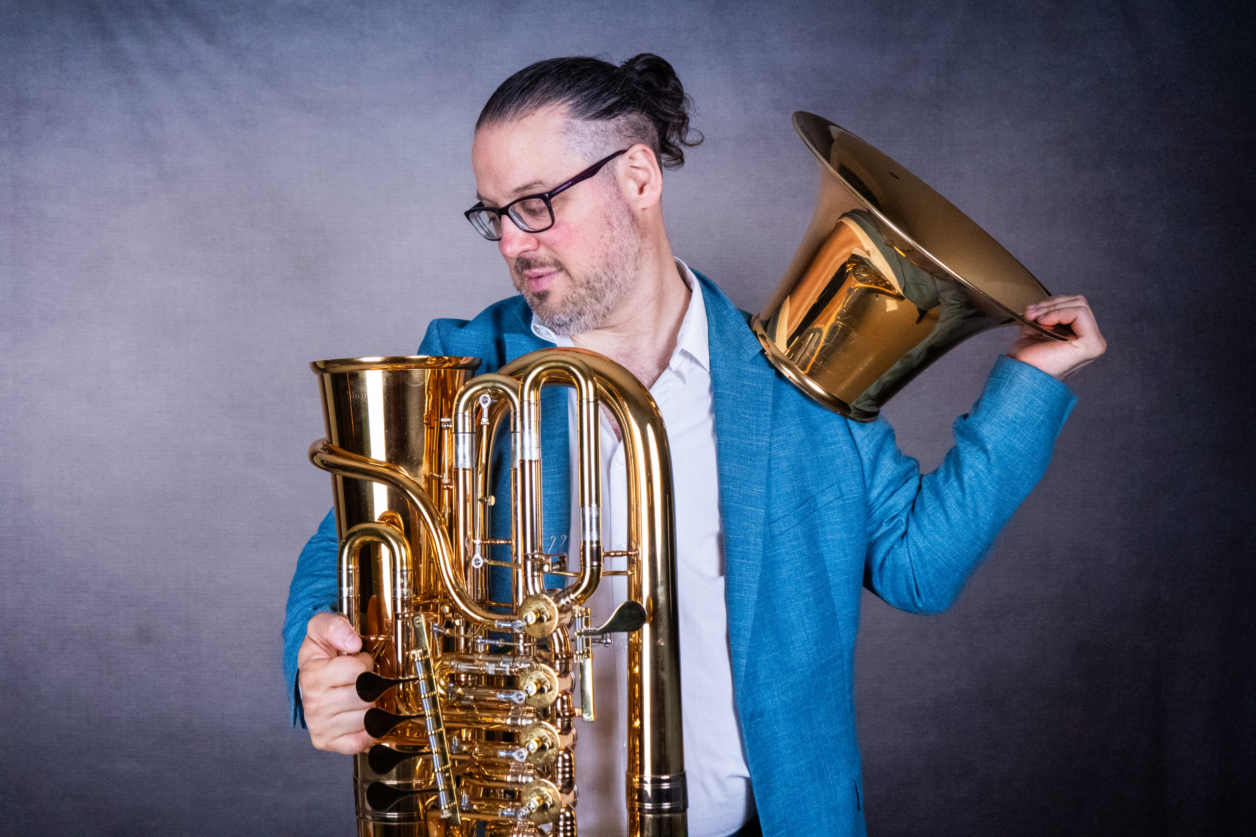 Patricio Cosentino hält eine Tuba und hebt einen losen Schallbecher